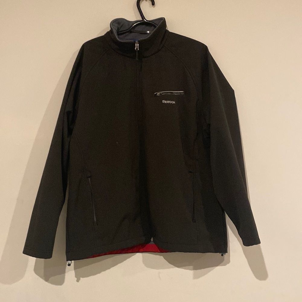 Black Reebok wind breaker.